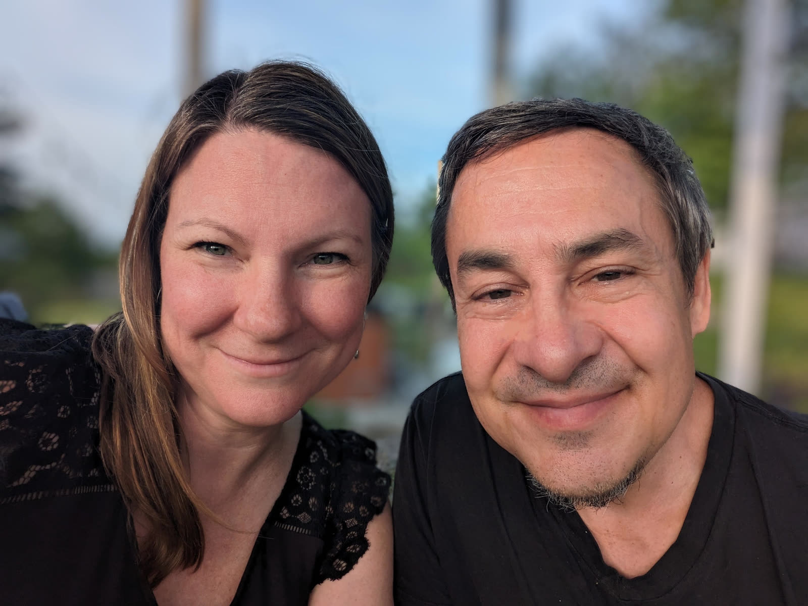 Paul and Erica outside on the farm at golden hour.